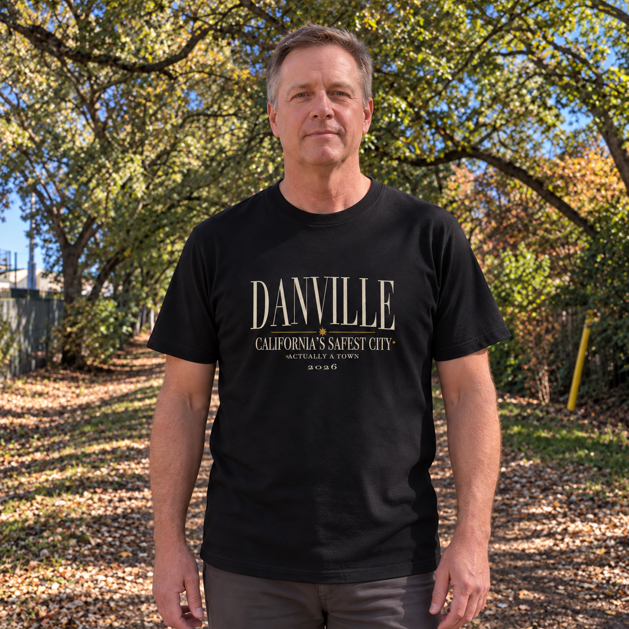 Safest city, actually a town Organic tee in Black worn on the Iron Horse Trail — digital product visualization